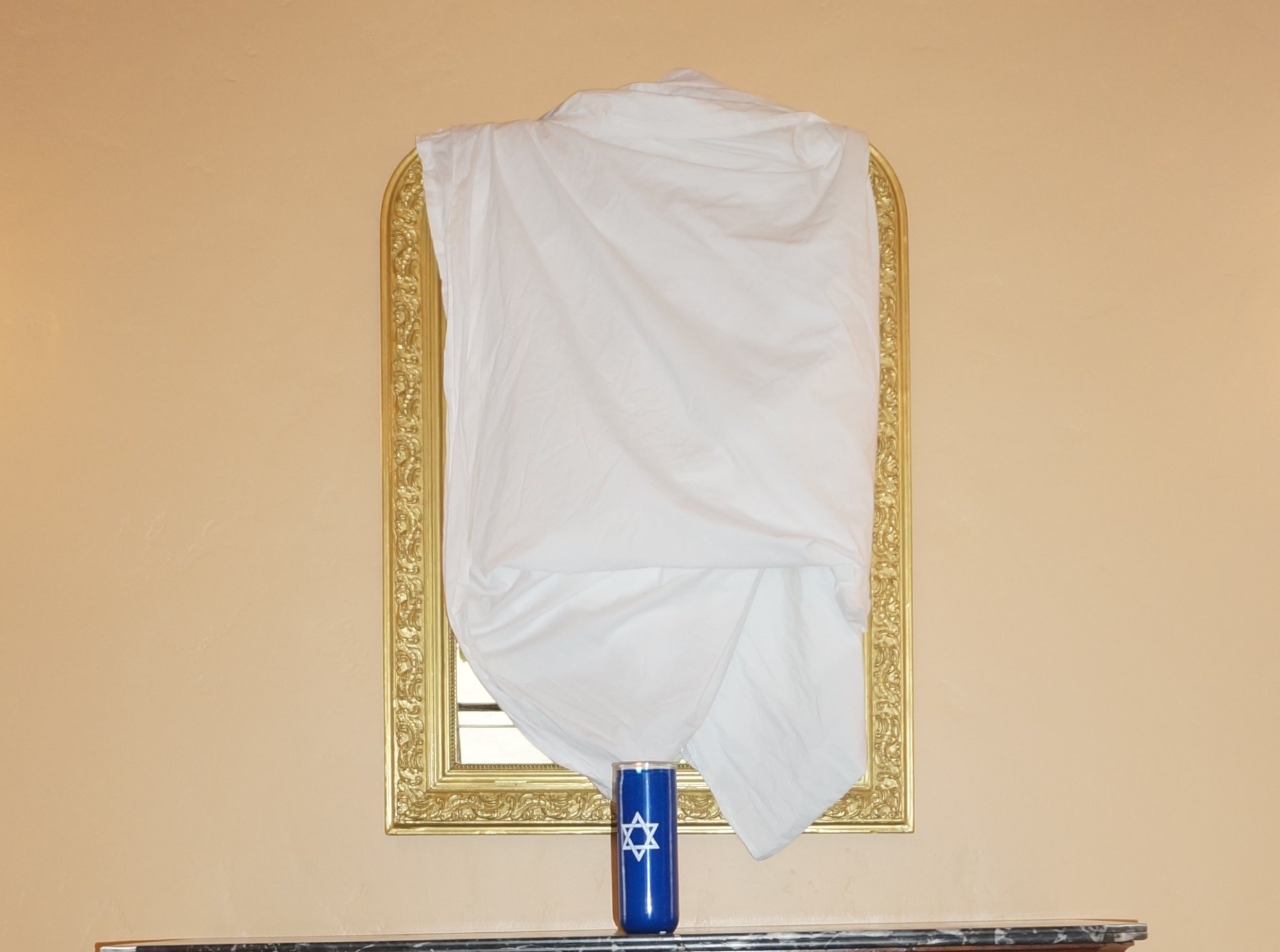 Covered mirror with yahrzeit candle